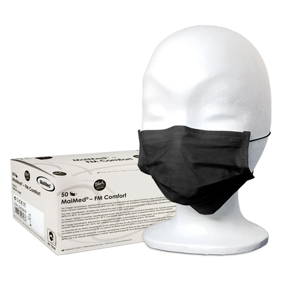 Schwarze Einweg-Gesichtsmaske MaiMed auf weißem Modellkopf mit Verpackung im Hintergrund