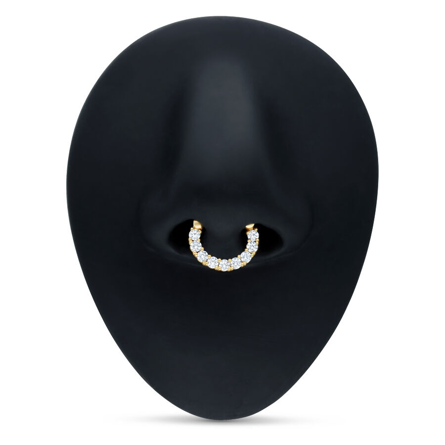 Goldener Septum Clicker mit klaren Kristallen auf schwarzem Hintergrund