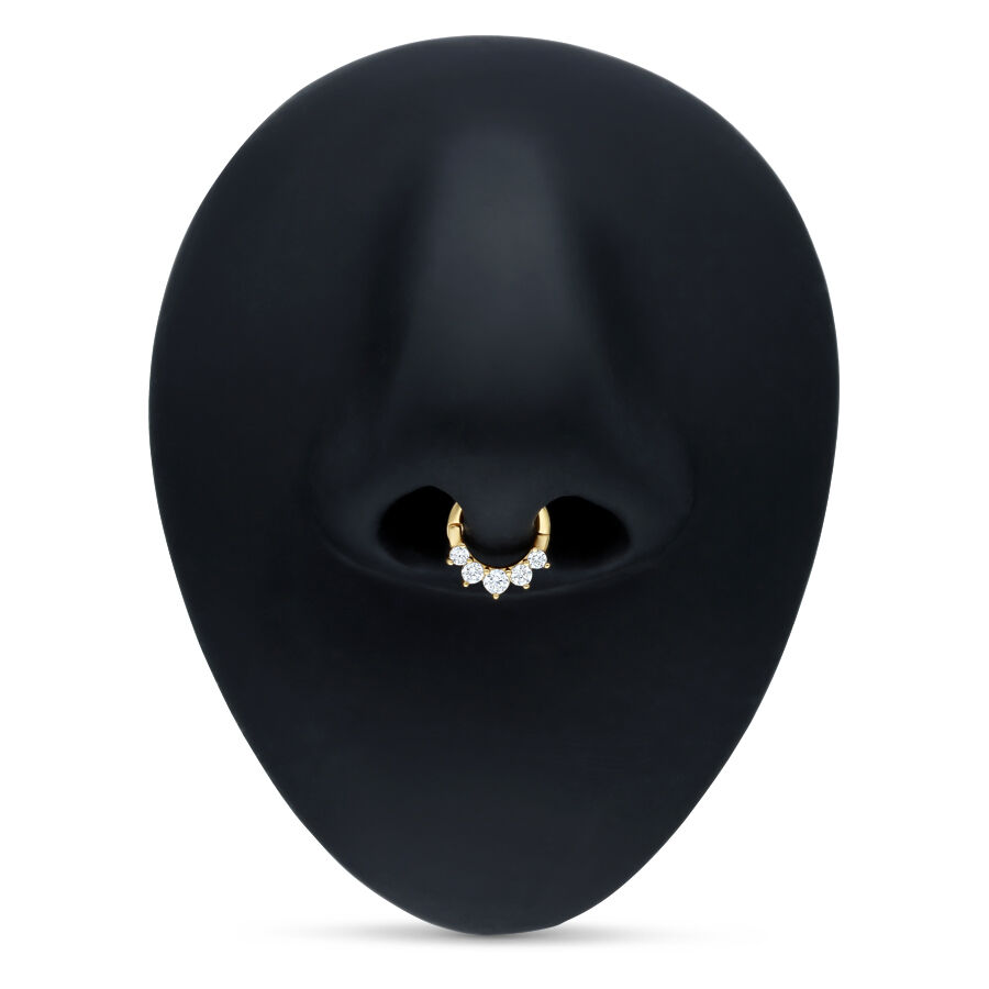 Goldener Septum Clicker mit klaren Kristallen auf schwarzem Hintergrund
