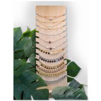 Holzdisplay mit schwarzen Kunstlederakzenten, umgeben von Pflanzen