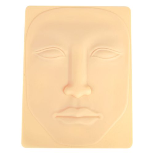 Beige Silikon-Tattoo-Haut in Gesichtform auf hellem Hintergrund