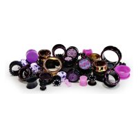 Verschiedene Piercings in Lila und Gold auf weißem Hintergrund