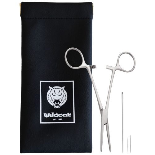 Silberne Piercingzange und Nadeln neben schwarzer Tasche mit Wildcat-Logo