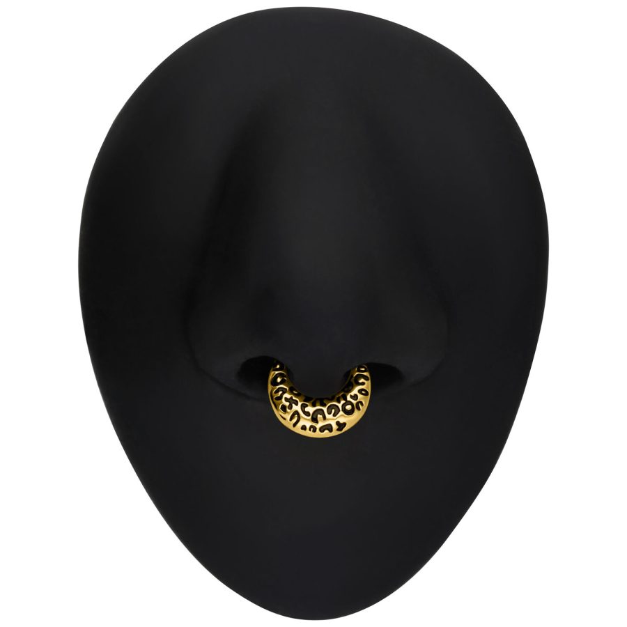 Goldener Septum Clicker mit Leopardenmuster auf schwarzem Hintergrund