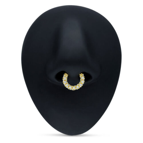 Goldener Septum Clicker mit klaren Kristallen auf schwarzem Hintergrund