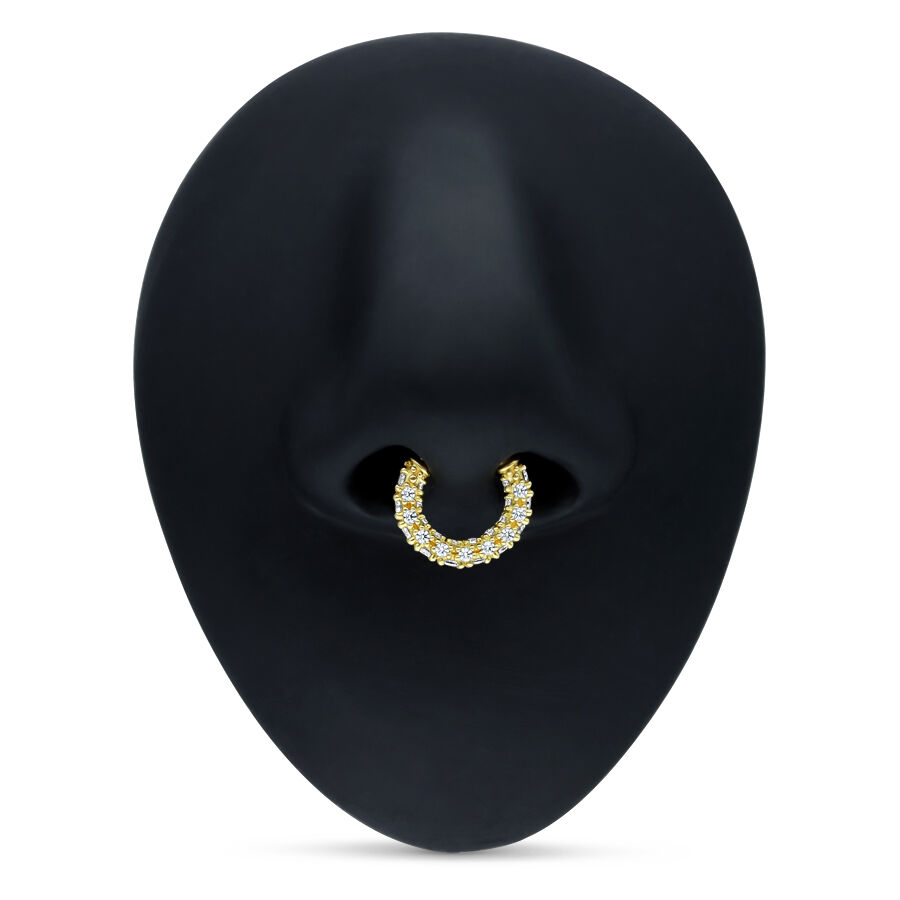 Goldener Septum Clicker mit klaren Kristallen auf schwarzem Hintergrund